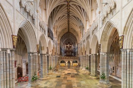 Interior view of a majestic gothic cathedral with vaulted ceilings and ornate details, showcasing architectural grandeur