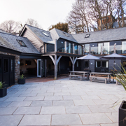 Modern courtyard with contemporary architecture, featuring large patio and outdoor seating in a serene garden setting